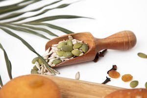 A Pumpkin Seeds on a Wooden Scooper